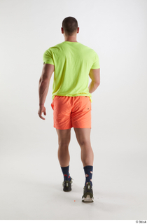 Joel  1 back view dressed green sneakers orange shorts…